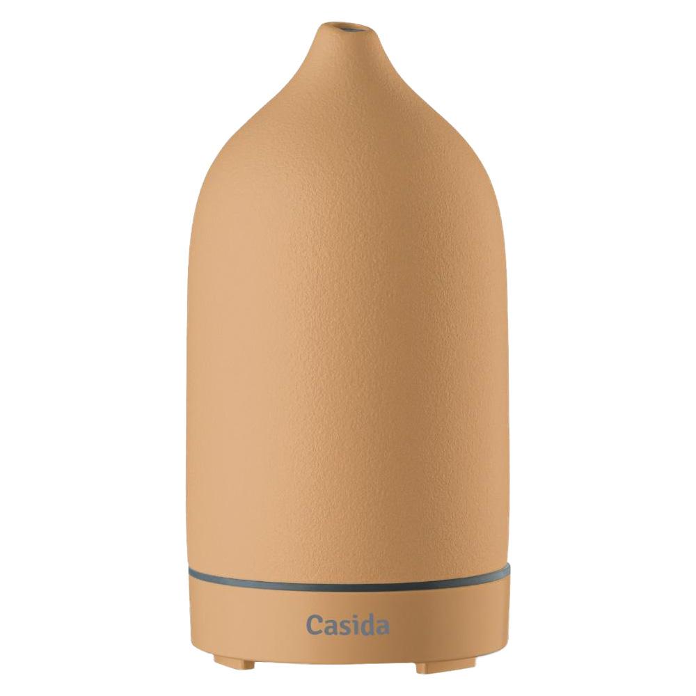 Beiger, flaschenförmiger Duftzerstäuber mit kleinem Auslass oben.